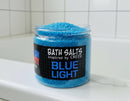 Jar of blue bath salts labeled 'Blue Light' inspired by Creed on a bathroom shelf.