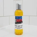 Bottle of Fresh for Duty shower gel on a tiled bathroom wall.